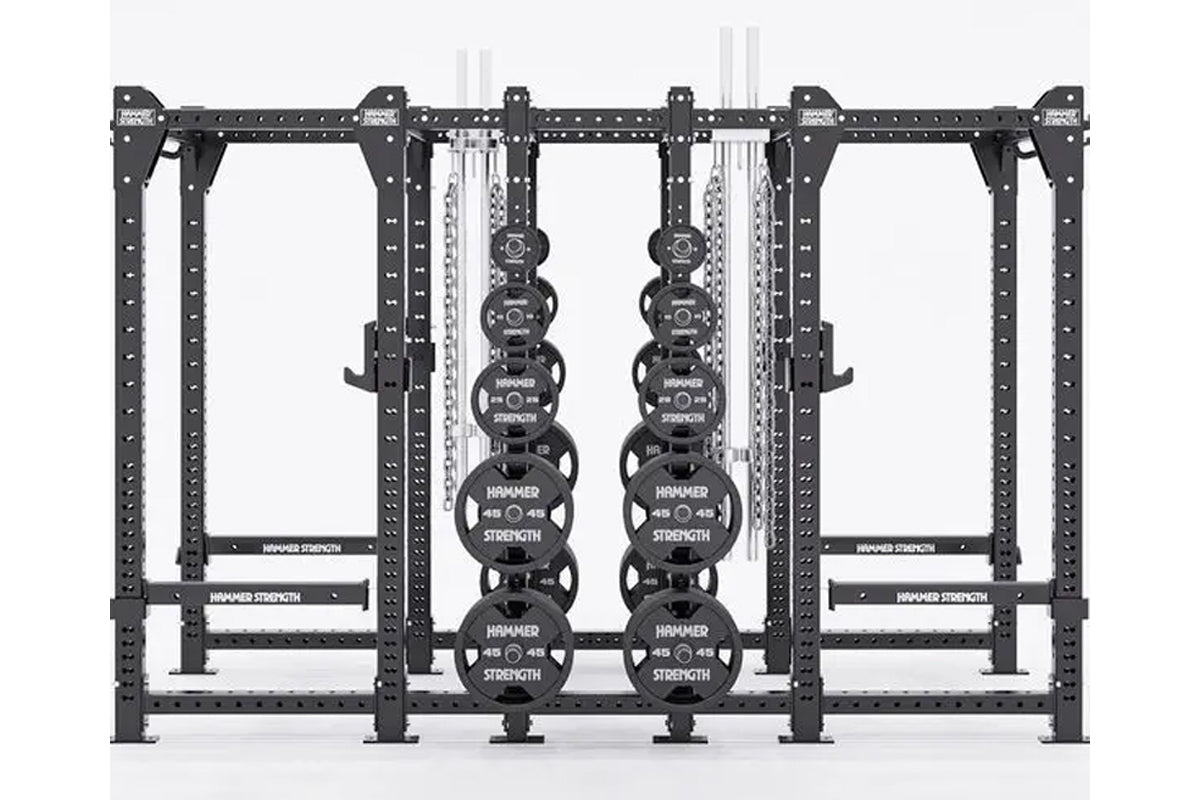 Black Hammer Strength HD Elite ID combo rack with perforated uprights, weight plate storage, and hanging chains on white back