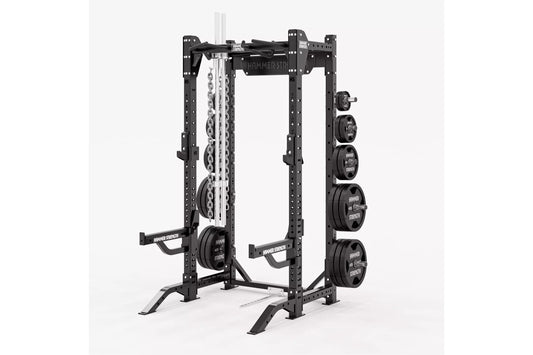 Black Hammer Strength HD Elite ID half rack with adjustable weight plate storage, chain attachment, and barbell on white back