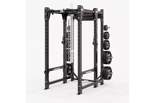 Black power rack with perforated uprights, adjustable safety bars, cable machine attachment on center post, and weight plate 