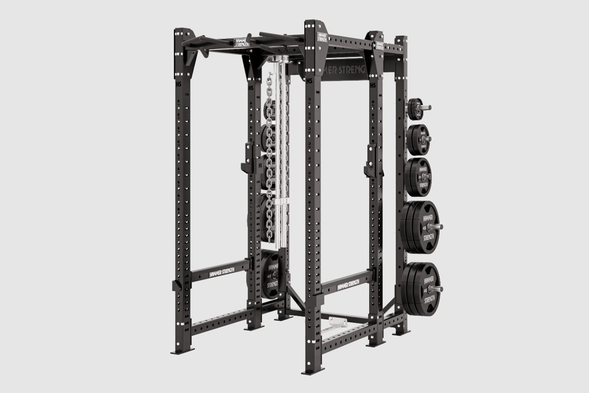 Black steel power rack with pull-up bar, weight plate pegs on right side, and chain storage, on white background