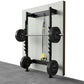 Wall-mounted squat rack with black metal frame, loaded barbell with weight plates, yellow suspension straps, and concrete flo