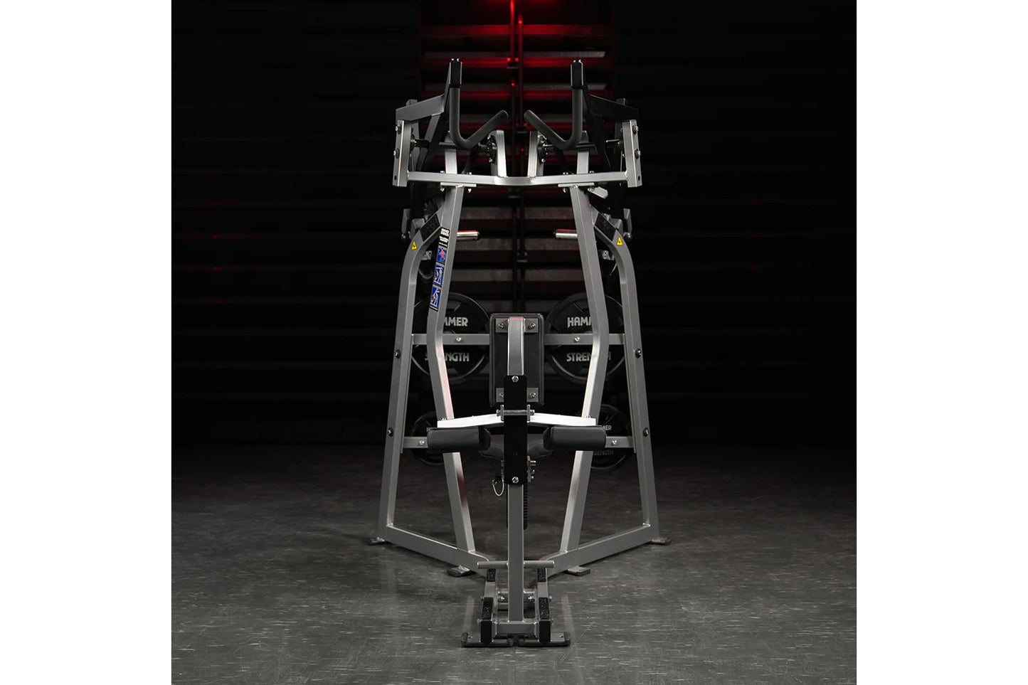 Hammer Strength Iso-Lateral High Row machine with gray steel frame and black handles, front view on dark background