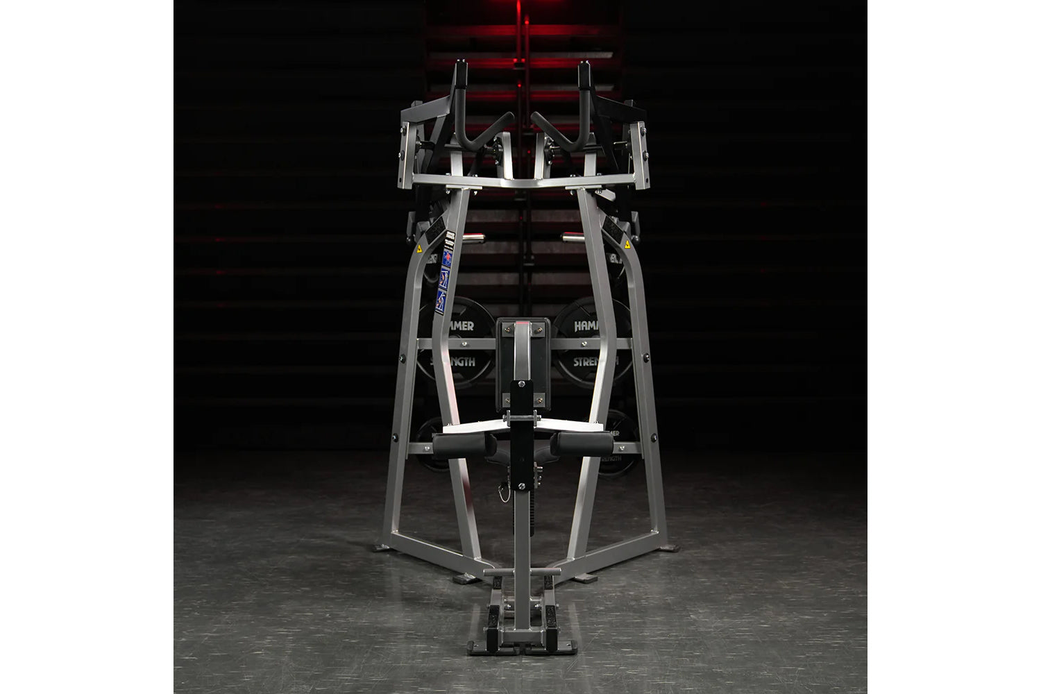 Hammer Strength Iso-Lateral High Row machine with gray steel frame and black handles, front view on dark background