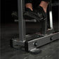 Person in black sneakers using Hammer Strength Iso-Lateral High Row machine in gym setting