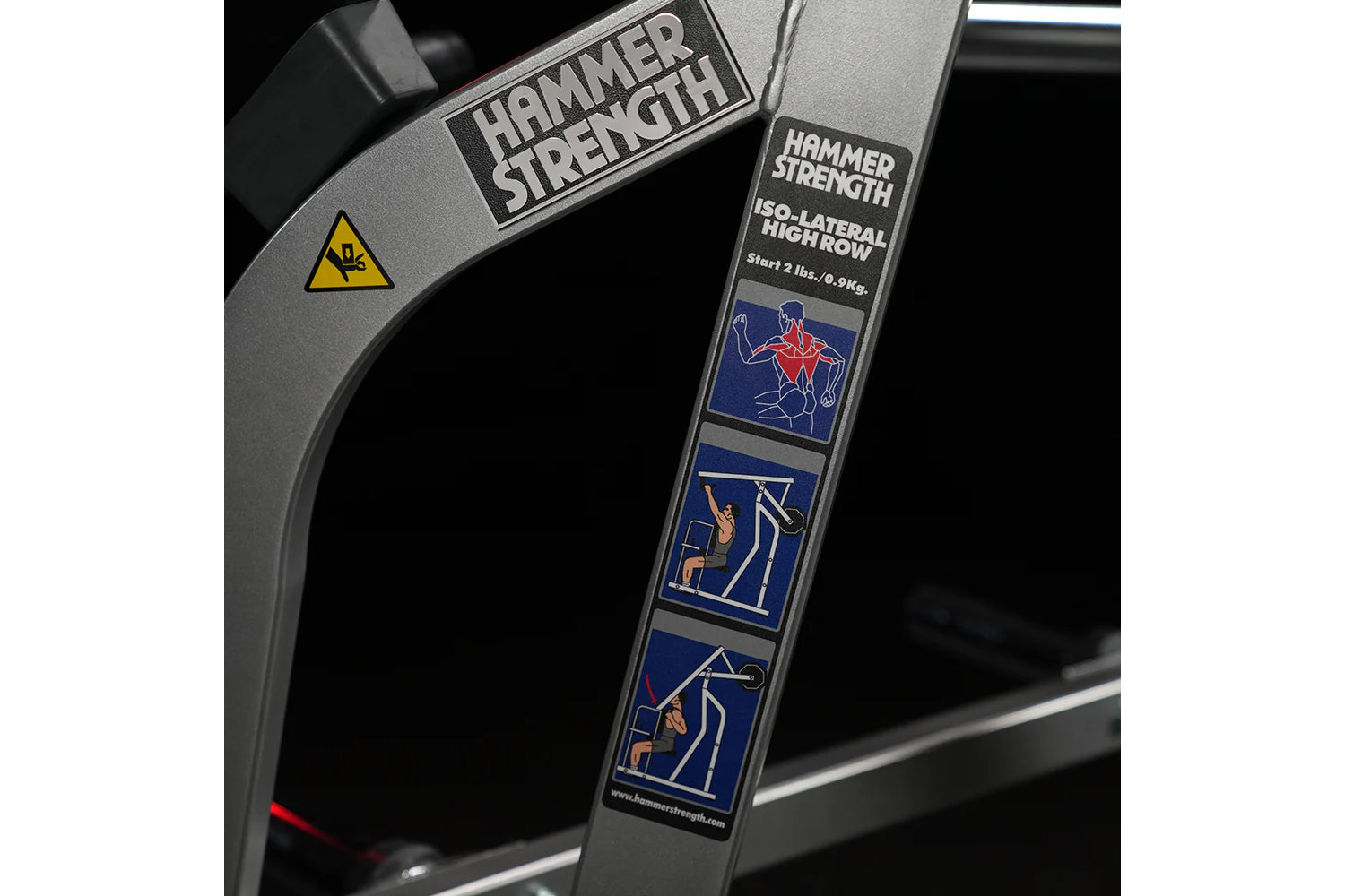 Hammer Strength Iso-Lateral High Row machine with gray frame and instruction graphics on vertical pad, close-up detail view