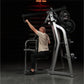 Man using black and silver Hammer Strength iso-lateral high row machine with weighted plates in gym setting