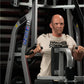 Man wearing beige Hammer Strength t-shirt using gray and black Hammer Strength Iso-Lateral High Row machine in gym setting
