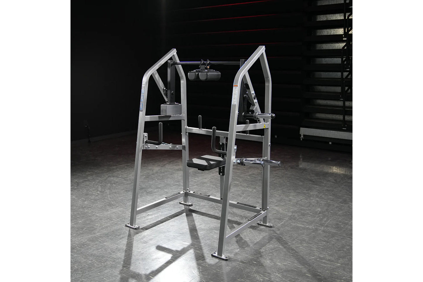 Hammer Strength plate-loaded 4-way neck machine with silver frame and black handles on gym floor