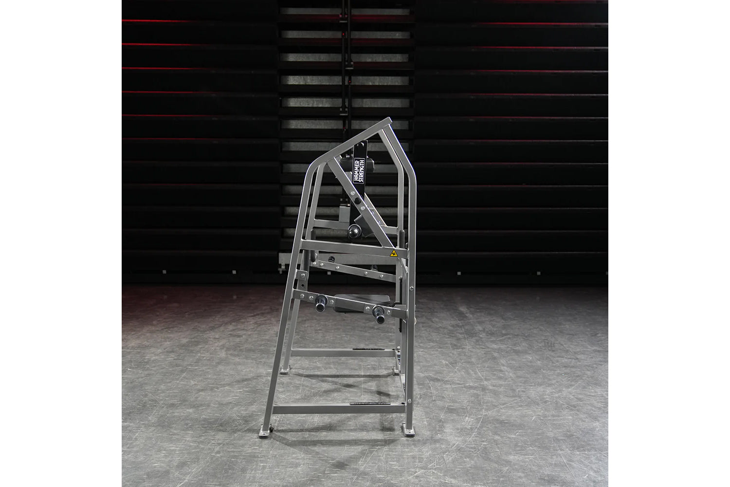 Hammer Strength plate-loaded 4 way neck machine with gray metal frame and multiple adjustment handles, on concrete floor