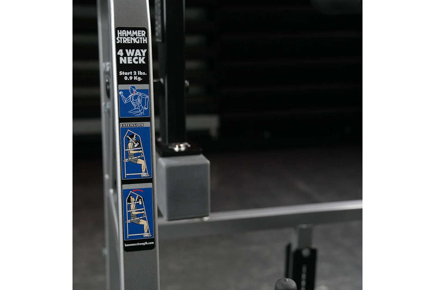 Hammer Strength 4 Way Neck plate-loaded machine with instruction decals on gray frame, front view