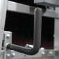 Black foam-padded neck exercise handle with J-shaped grip design mounted on plate-loaded machine