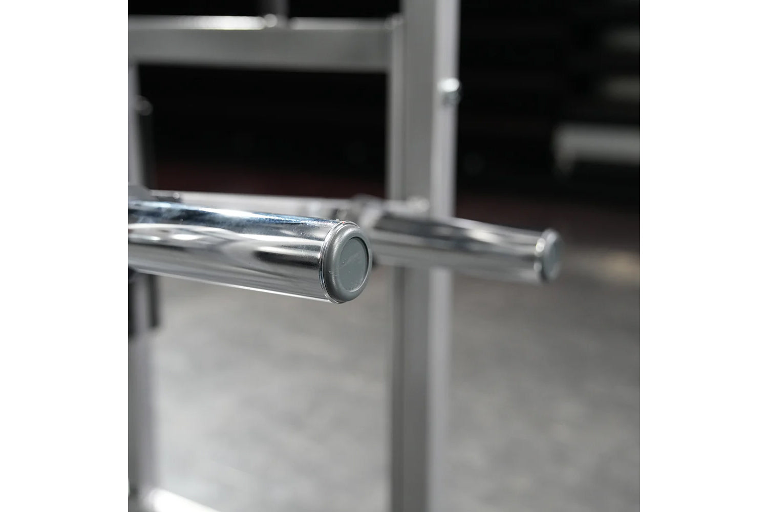 Polished chrome handle bar with gray end cap on Hammer Strength plate-loaded neck machine