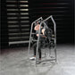 Man using silver Hammer Strength plate-loaded 4-way neck machine with weight plates in gym setting