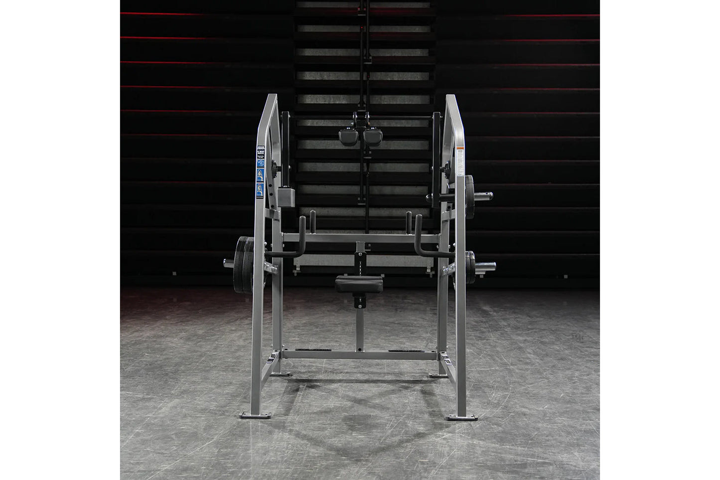 Hammer Strength plate-loaded 4-way neck exercise machine with silver frame and weight plates, front view on gym floor