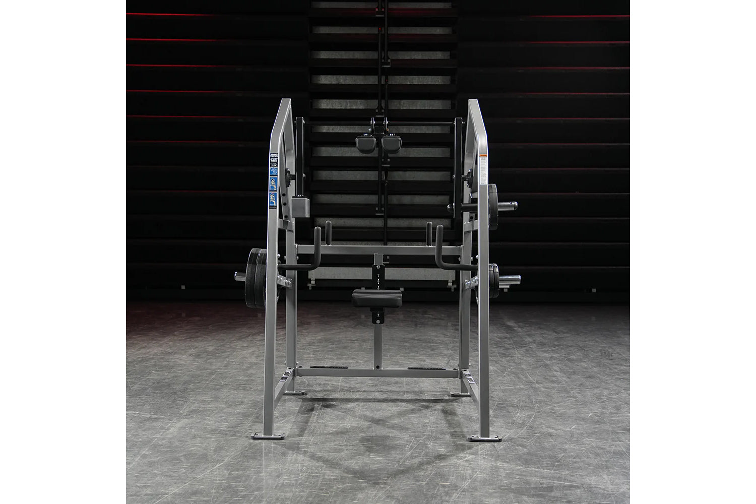 Hammer Strength plate-loaded 4-way neck exercise machine with silver frame and weight plates, front view on gym floor