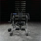 Black and silver plate-loaded abdominal oblique crunch machine with digital display, foot platform, and adjustable seat, fron
