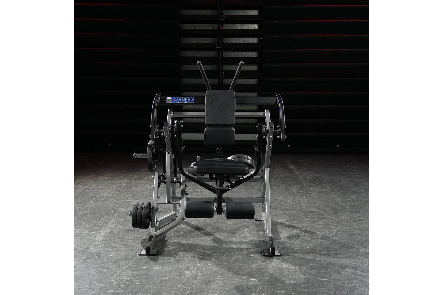 Black and silver plate-loaded abdominal oblique crunch machine with digital display, foot platform, and adjustable seat, fron