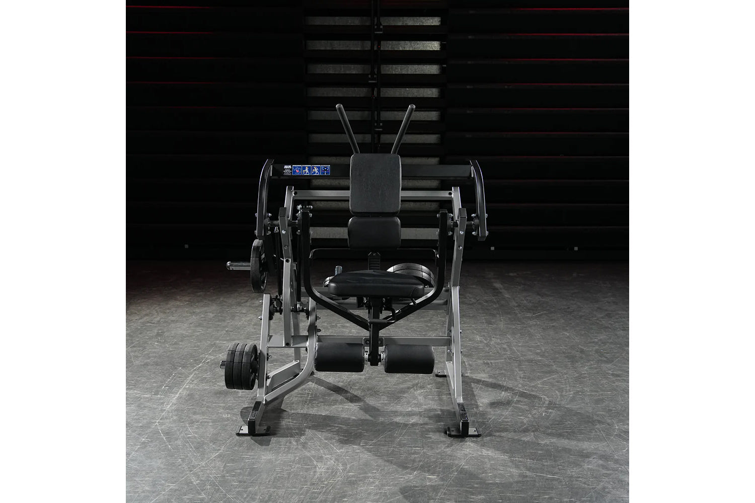 Black and silver plate-loaded abdominal oblique crunch machine with digital display, foot platform, and adjustable seat, fron