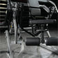 Hammer Strength plate-loaded abdominal oblique crunch machine with black leather seat and adjustable arm pads on white frame
