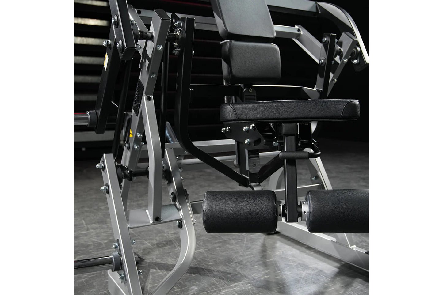 Hammer Strength plate-loaded abdominal oblique crunch machine with black leather seat and adjustable arm pads on white frame
