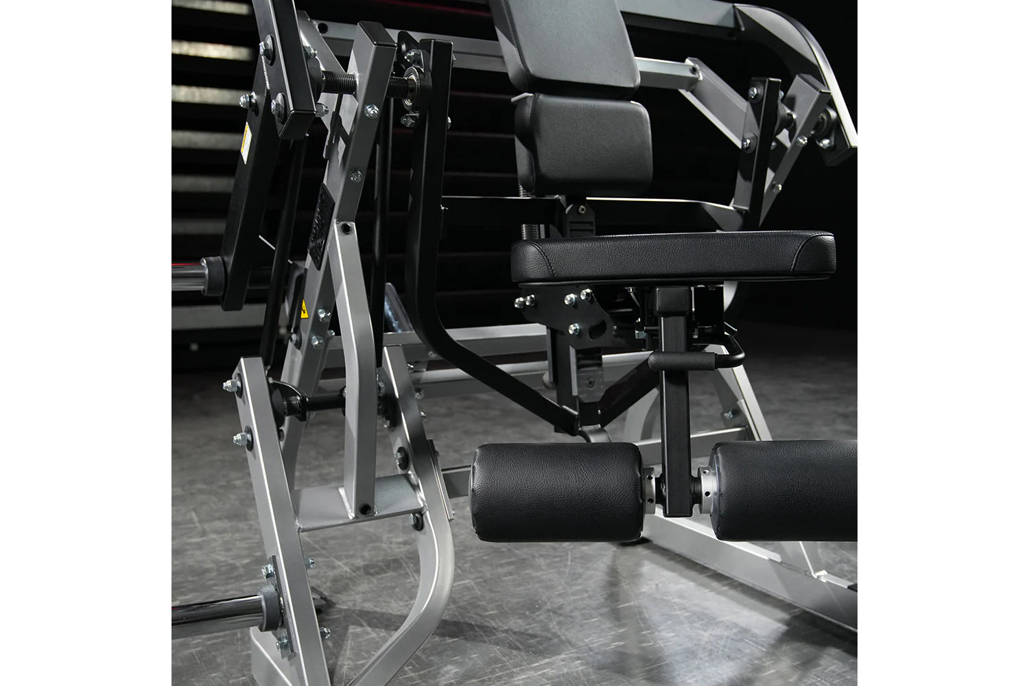 Hammer Strength plate-loaded abdominal oblique crunch machine with black leather seat and adjustable arm pads on white frame