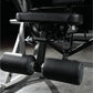 Black and silver plate-loaded abdominal oblique crunch machine with padded black leather handles and foot platform in gym set