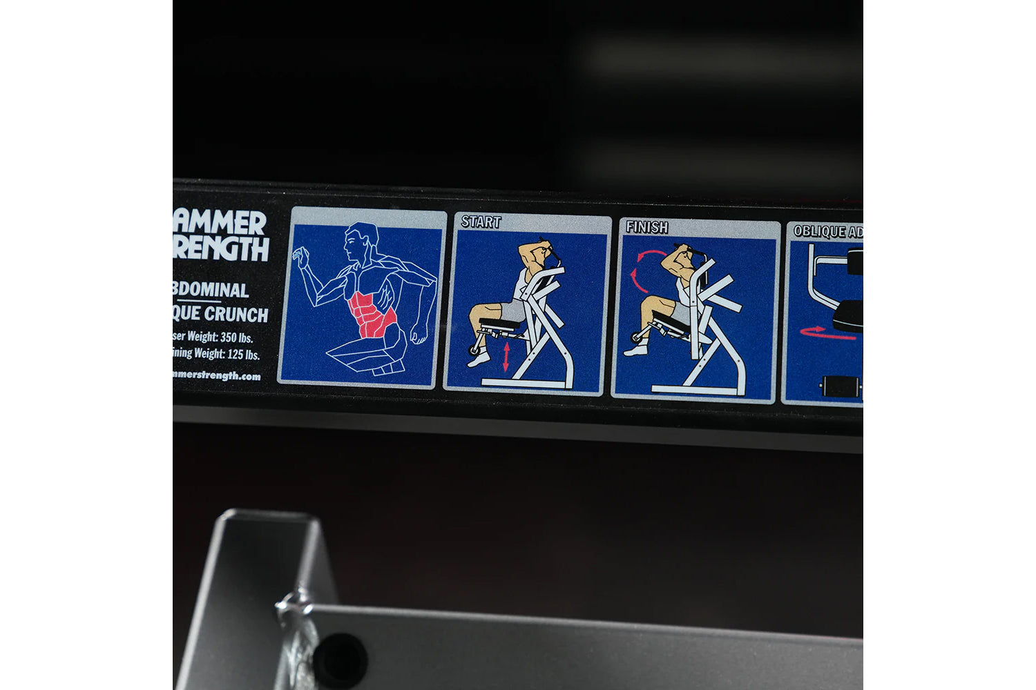 Hammer Strength plate-loaded abdominal crunch machine with instruction decals showing exercise form on blue background