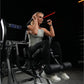 Woman wearing gray sleeveless tank top and black leggings using Hammer Strength plate-loaded abdominal oblique crunch machine