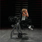 Woman using black Hammer Strength plate-loaded abdominal oblique crunch machine in gym setting, wearing white tank top and sn