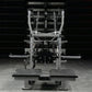 Hammer Strength plate-loaded belt squat machine with silver frame, dual foot platforms, and weight plate pegs, shown in comme