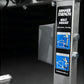 Hammer Strength plate-loaded belt squat machine with gray frame, black and blue instructional labels, and adjustment controls