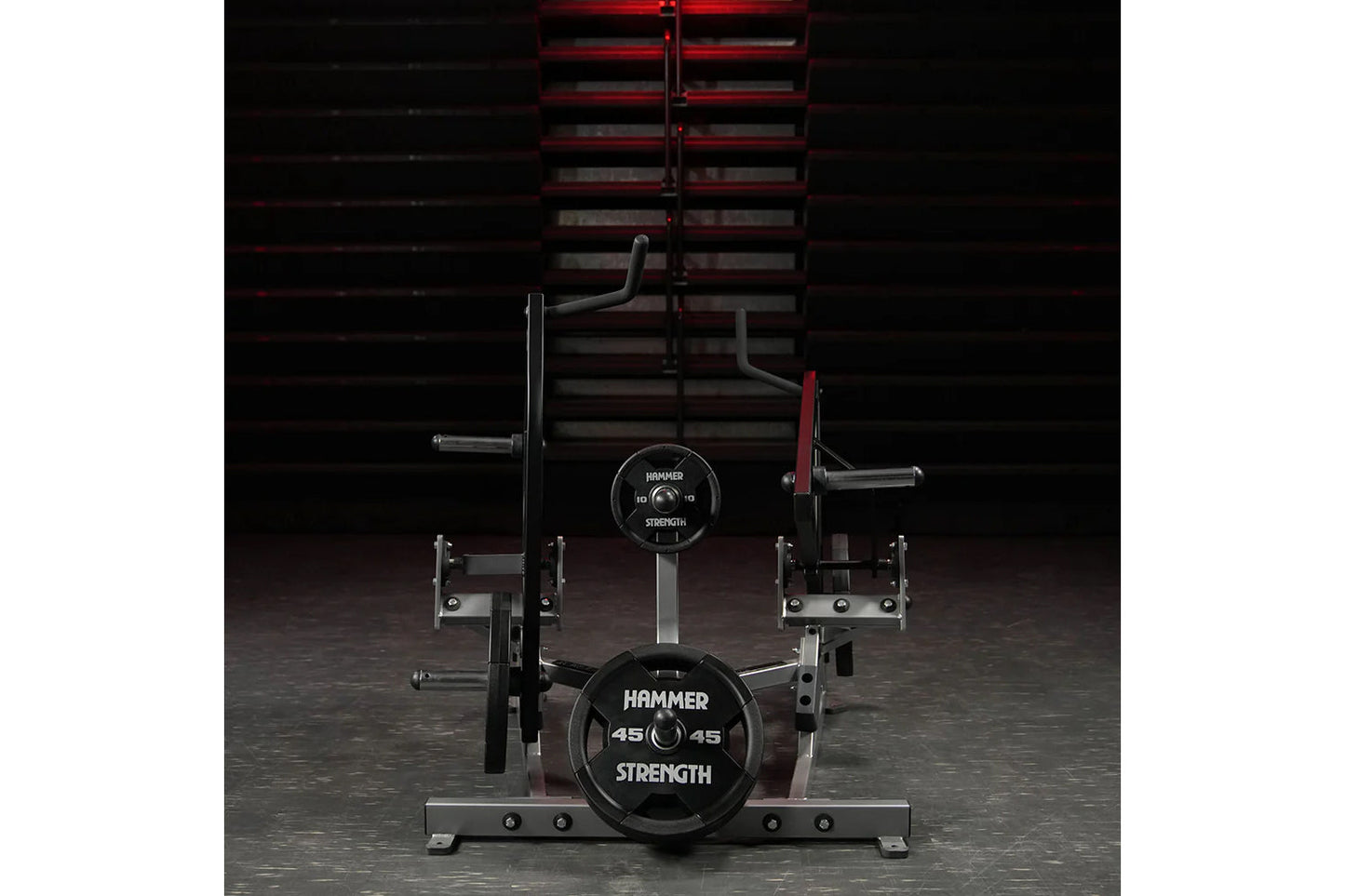 Hammer Strength plate-loaded combo twist machine with black weight plates, curved handles, and red steel frame in gym setting
