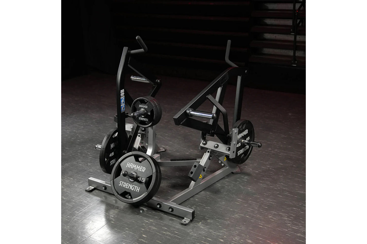 Hammer Strength plate-loaded combo twist machine with black frame, adjustable handles, and 45-pound weight plates in gym sett