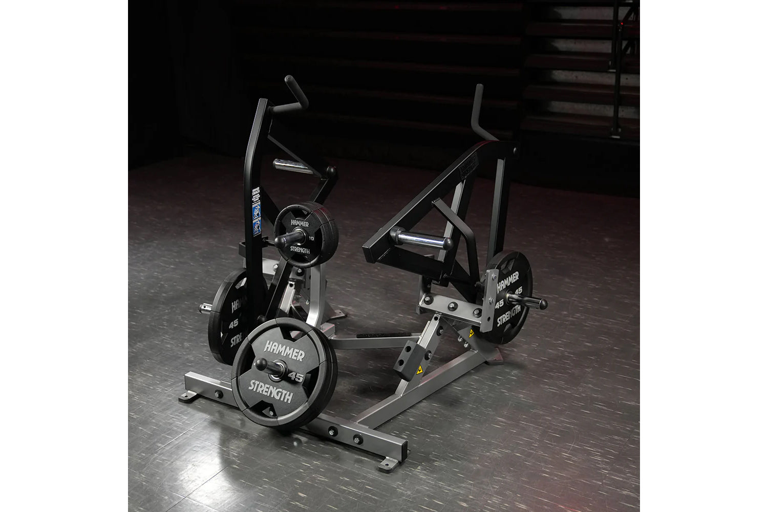 Hammer Strength plate-loaded combo twist machine with black frame, adjustable handles, and 45-pound weight plates in gym sett