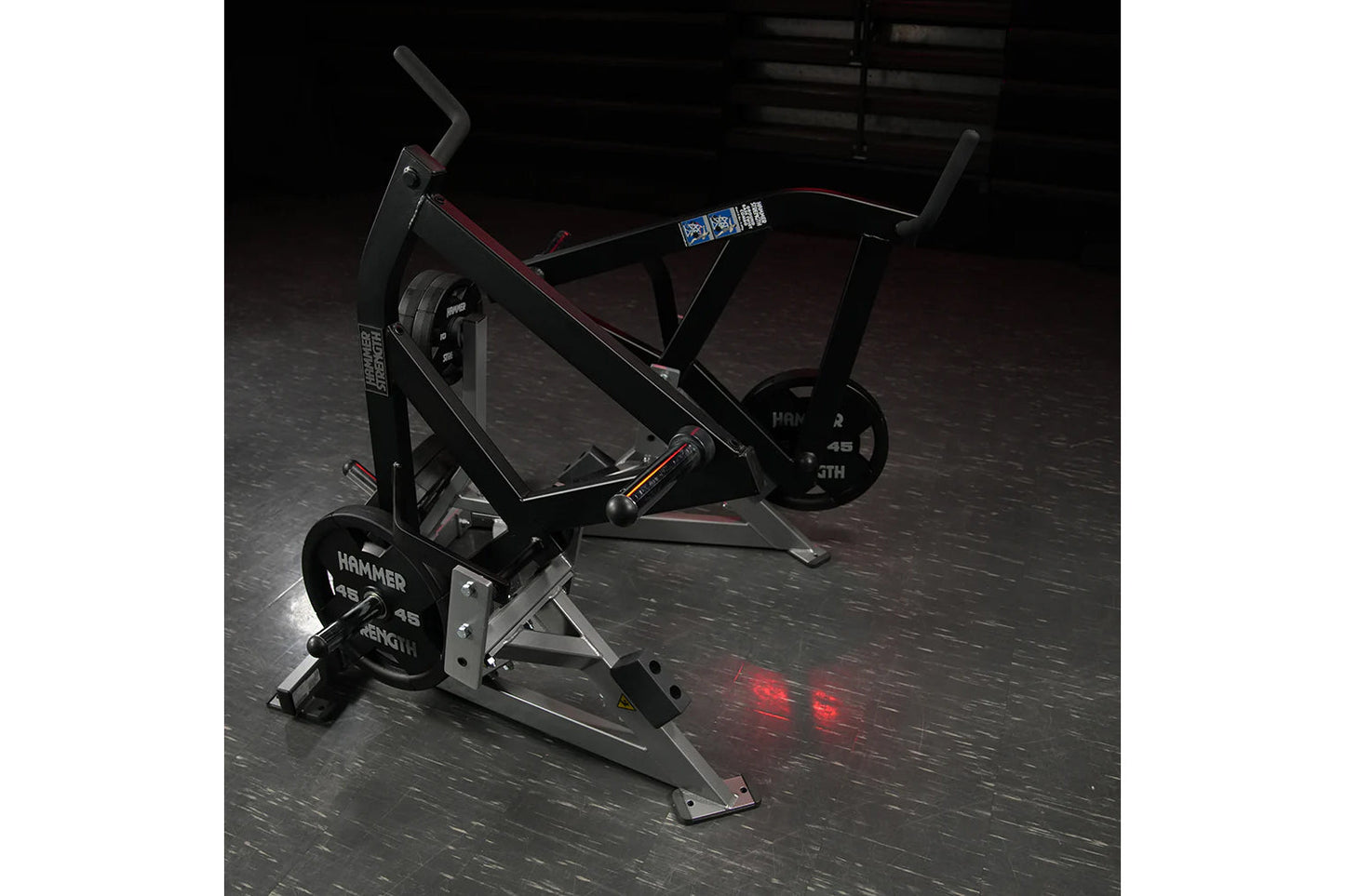 Hammer Strength black plate-loaded combo twist machine with red accents on gym floor
