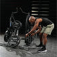 Man using black Hammer Strength plate-loaded combo twist machine in gym setting, wearing black sleeveless shirt and tan short