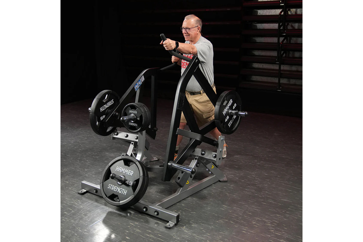 Man using gray and black Hammer Strength plate-loaded combo twist machine with weighted plates in gym setting