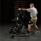 Man using black Hammer Strength plate-loaded combo twist machine in gym setting, wearing gray shirt and khaki shorts