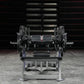 Hammer Strength plate-loaded glute drive machine with black weight plates and gray metal frame in gym setting