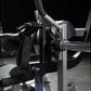 Black nylon strap and metal foot plate attachment on Hammer Strength plate-loaded glute drive machine with gray frame