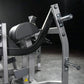 Hammer Strength plate-loaded glute drive machine with silver frame, black padded seat and backrest, chrome handles, on dark b