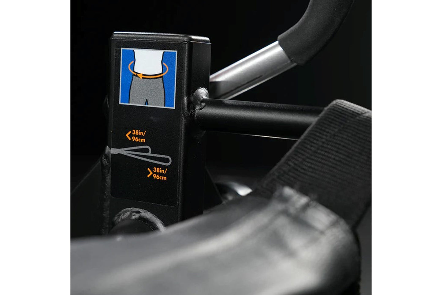 Black plate-loaded glute drive machine with blue and white instructional graphic on side panel, showing 38in/96cm measurement
