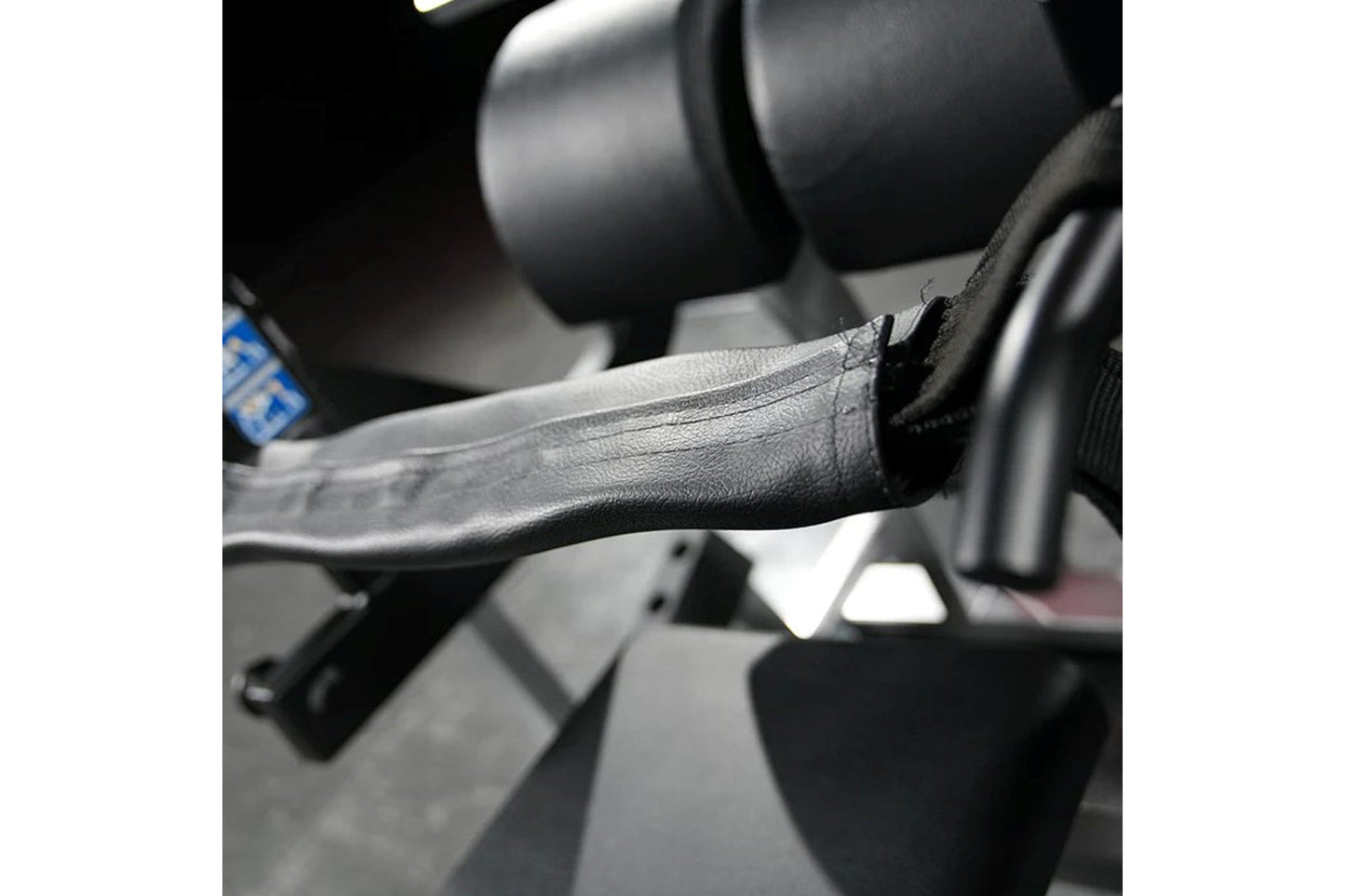 Black and gray lever arm with textured grip on Hammer Strength plate-loaded glute drive machine