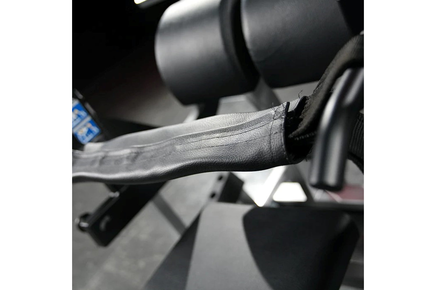 Black and gray lever arm with textured grip on Hammer Strength plate-loaded glute drive machine