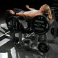 Woman using black Hammer Strength plate-loaded glute drive machine with 45-pound plates in gym setting
