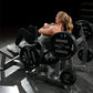 Woman using Hammer Strength plate-loaded glute drive machine with black weight plates in gym setting