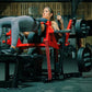 Woman in gray textured leggings using red Hammer Strength plate-loaded glute drive machine in gym setting