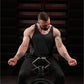 Man wearing black tank top and black pants using plate-loaded gripper machine with industrial staircase background