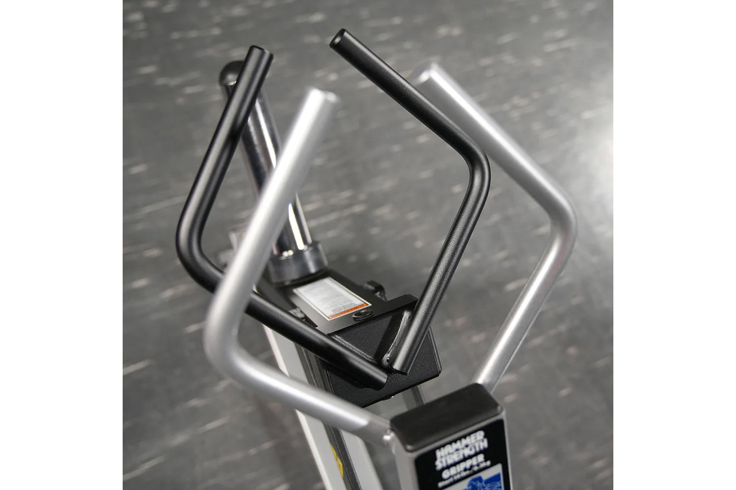 Hammer Strength plate-loaded gripper machine with dual black and silver handles on gray textured background