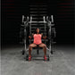 Athlete wearing coral pink tank top and red sneakers performing chest press on Hammer Strength plate-loaded machine in gym se